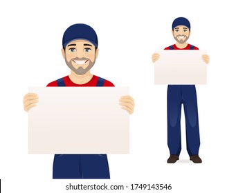 Handsome man in blue overalls holding empty blank board isolated vector illustration