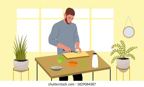 Handsome man cooking, cuts apples, carrots with a knife. concept of vegetarianism, healthy food. Man looks after his health. Kitchen table, cutting board, vegetables, salad bowl, fruits, milk bottle.
