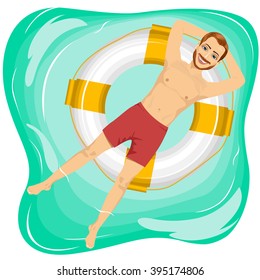 Handsome Man Floating On An Inflatable Circle In The Pool