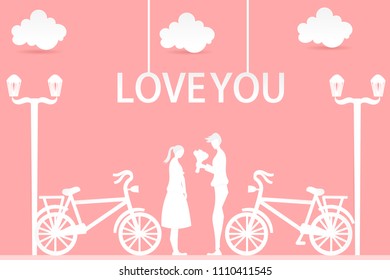 Handsome man presenting flowers to his girlfriend isolated on a pink background 