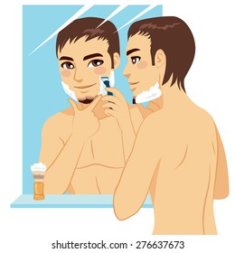 Handsome man shaving his face with razor after applying foam cream in front of mirror