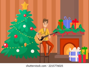 Handsome man sits near fir tree with guitar and sings festive song. New Year and Christmas. Winter celebration and holidays. Happy vocalist performs verses with melody at family party with fireplace