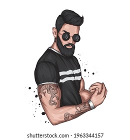 Handsome muscular guy with stylish hair, beard and tattoos. Hipster. Fashion and style, clothing and accessories.