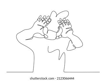 a handsome person looking through both hands. photographer shows focus with his hands
