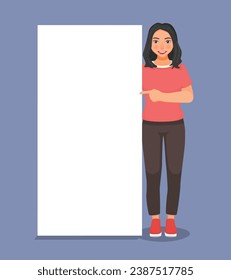 Handsome young woman standing beside blank banner pointing finger copyspace for ads