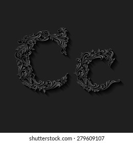 Handsomely decorated letter c in upper and lower case on black