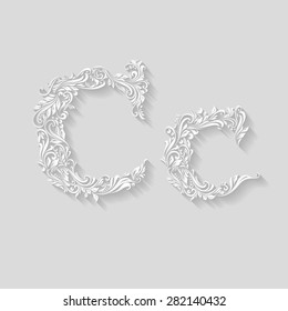 Handsomely decorated letter C in upper and lower case on gray