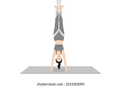 Handstand Pose Aerial. Beautiful girl practice Adho Mukha Vrksasana Aerial. Young attractive woman practicing yoga exercise. working out, black wearing sportswear, grey pants and top, indoor full