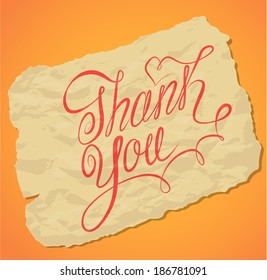 Handwritten calligraphy text Thank You over old yellow paper background.
