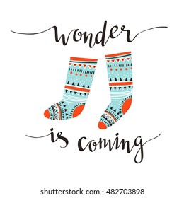 Hand-written Christmas lettering and christmas socks for gifts isolated on white background.  Season vector holiday  design with calligraphy - Wonder is coming.