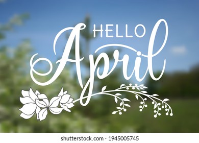 Handwritten, hello april, lettering message. April welcome quote with leaves . Modern lettering. Hello April design for cards, banners, posters. Blurred background.