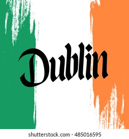 Handwritten inscription Dublin and brush strokes in colors of the national flag of Ireland. Hand drawn lettering. Calligraphic element for your design. Vector illustration.