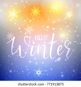 Handwritten modern calligraphy Hello winter on glowing holiday background with snowflakes