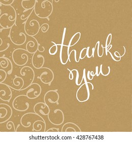 Handwritten vector lettering phrase Thank you. Brush lettering calligraphy style writing. Whimsical letters on craft paper looking background with hand drawn curly and floral decorative elements. 