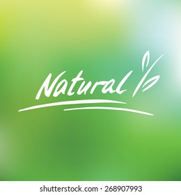 Handwritten vector logo. Natural. Plant. Green blurred background