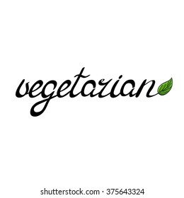 Handwritten word vegetarian decorated with a green leaf. Handwritten illustration, hand made brush lettering.