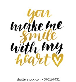 Handwritten "You make me smile with my heart" Valentine day card. modern calligraphy with golden paint texture