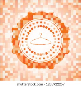 hanger icon inside abstract emblem, orange mosaic background
