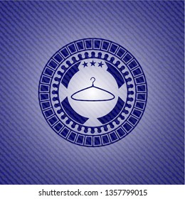 hanger icon inside badge with denim background