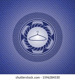 hanger icon inside badge with denim background