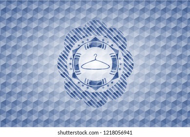 hanger icon inside blue emblem or badge with abstract geometric pattern background.