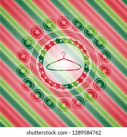 hanger icon inside christmas badge background.
