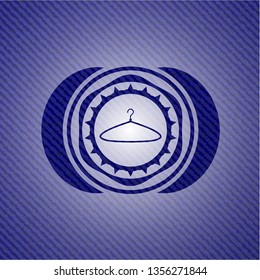 hanger icon inside emblem with denim texture