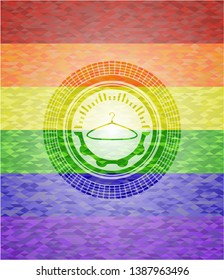 hanger icon inside emblem on mosaic background with the colors of the LGBT flag