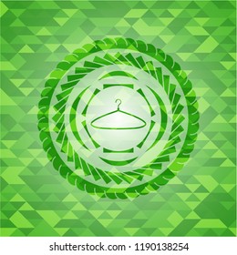 hanger icon inside green emblem with mosaic background