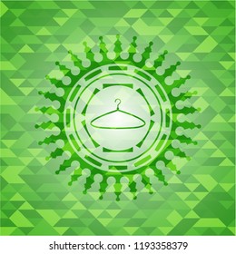 hanger icon inside green emblem with mosaic background