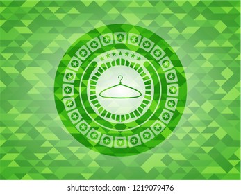 hanger icon inside green emblem with triangle mosaic background