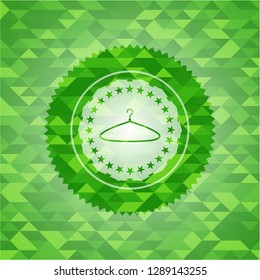 hanger icon inside green emblem with mosaic background