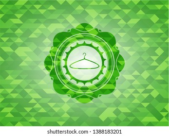 hanger icon inside green emblem with mosaic background