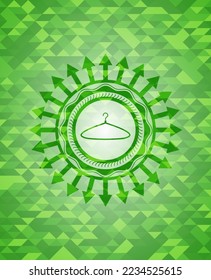 hanger icon inside green emblem with mosaic ecological style background. 