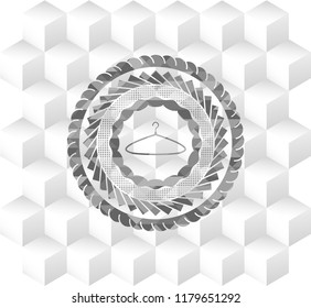 hanger icon inside grey emblem with geometric cube white background