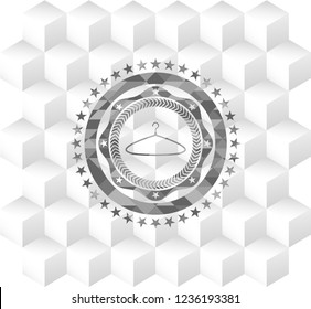 hanger icon inside grey emblem with geometric cube white background