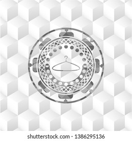 hanger icon inside grey emblem with geometric cube white background
