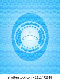 hanger icon inside light blue water wave badge background.