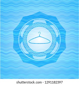 hanger icon inside light blue water wave emblem.