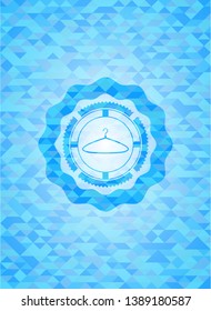 hanger icon inside light blue emblem with mosaic background