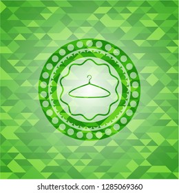 hanger icon inside realistic green mosaic emblem