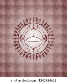 hanger icon inside red seamless emblem or badge with geometric pattern background.