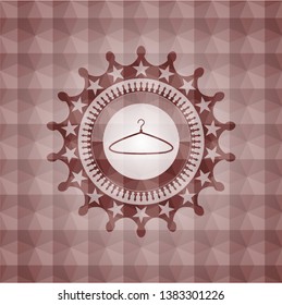hanger icon inside red seamless geometric emblem.
