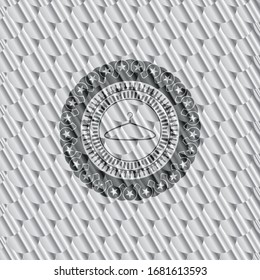 hanger icon inside shiny silver badge. Scales pattern. Vector Illustration. Detailed.