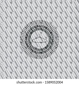 hanger icon inside silver shiny badge. Scales pattern. Vector Illustration. Detailed.