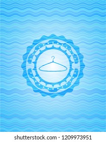 hanger icon inside sky blue water wave style emblem.