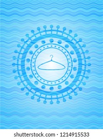 hanger icon inside water wave representation badge.