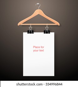 Hanger with paper sheet on dark background. Template for your design. It can be use for adv, promo, etc.