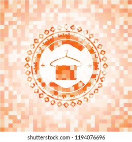 hanger with towel icon inside abstract orange mosaic emblem