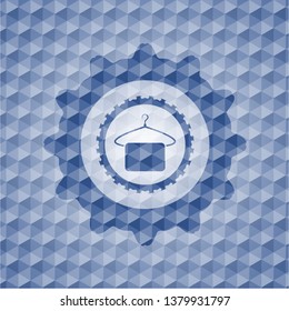 hanger with towel icon inside blue emblem or badge with abstract geometric pattern background.